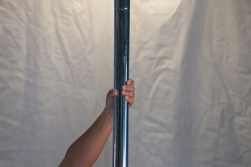 details of pole dancer's hands holding the pole. Concept sport, dance, health