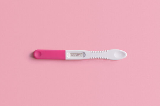Pregnancy test on pink background