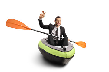 Businessman sitting in a kayak and waving