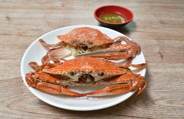 steamed flower crab on plate dipping Thai spicy seafood sauce