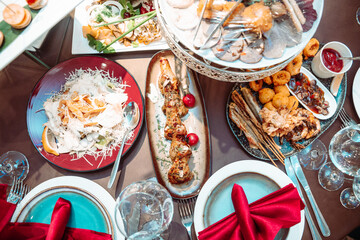 Different dishes on the table in restaurant at the festival. View from above.
