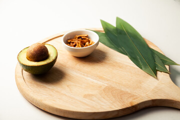 Avocado and nuts on a wooden board. Healthy food rich in protein. Ingredients full of healthy fat on the table. High quality photo