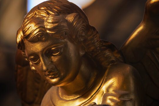 Gold angel Antique statue. Religion, faith, death, resurrection, eternity concept