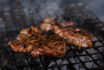 Grilled pork neck fillet steaks on grilled plate