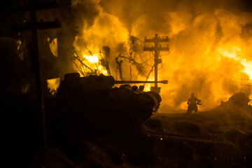 War Concept. Military silhouettes fighting scene on war fog sky background, World War Soldiers Silhouette Below Cloudy Skyline At night. Battle in ruined city. Selective focus