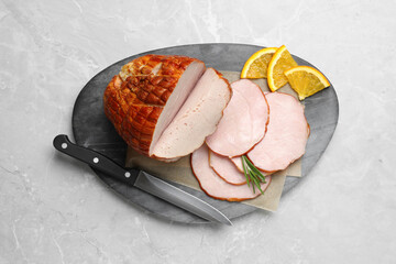 Delicious sliced ham with orange and rosemary on grey marble table, top view