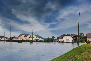 Extreme heavy rain storm weather. Flooded streets of the neighborhood. A flooded road junction with...