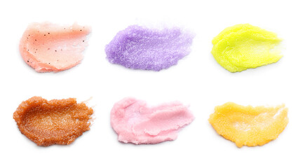 Set with smears of different body scrubs on white background