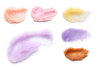 Set with smears of different body scrubs on white background
