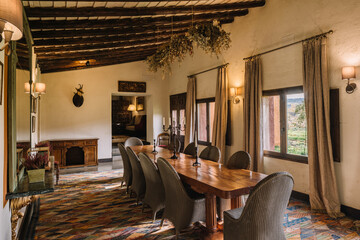 Dining room with wooden furniture and curtains on windows