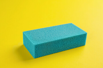 Pumice stone on yellow background. Pedicure tool