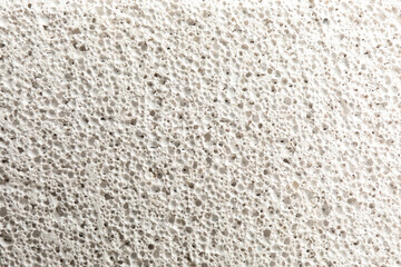 Texture of white pumice stone as background, closeup