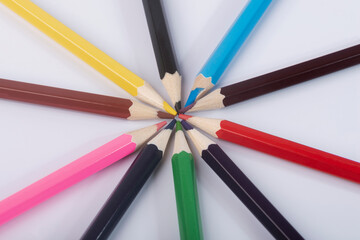 Colored pencils on an isolated white background close-up. Colored pencils for drawing a colored rainbow. 