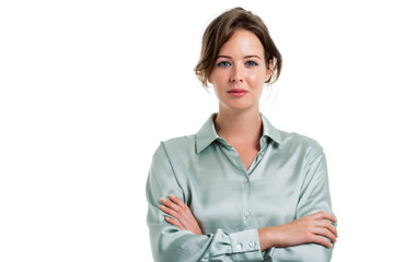 Smiling businesswoman portrait while standing at isolated background. Studio portrait of attractive young woman standing against white background. Copy space. 