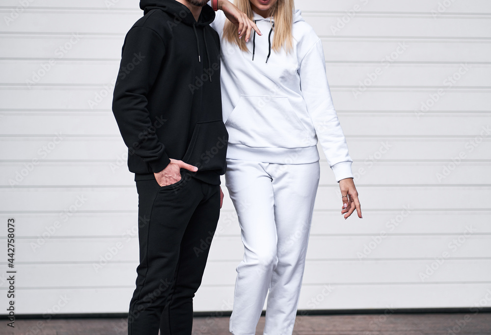 Wall mural Pair of man and woman is wearing hooded sweatshirt. Copy space hoodie design for branding clothes - Wall murals