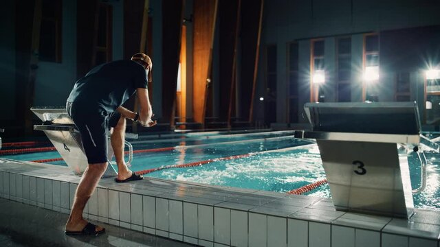 Swimming Pool: Professional Trainer Training Future Champion Swimmer. Experienced Coach Does High-Five with Successful Male Swimmer. Team Ready for World Record and Victory. Cinematic Wide Slow Motion