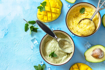 Ice cream, summer sweet snack or dessert. Homemade avocado and mango fruit ice cream, tropical...