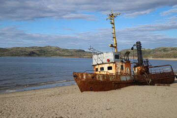 an abandoned fishing schooner on the seashore