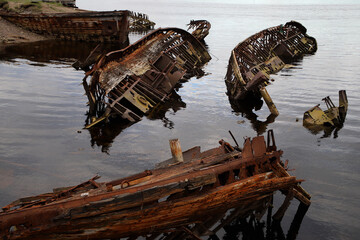 the skeletons of old sunken ships in the coastal waters of the north sea