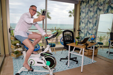 Business man in a multifunctional room at home. Working and sporting in the same place.