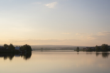 Fototapeta na wymiar sunset on the pond in the village in summer