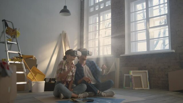 Young man and woman watching layout in vr glasses. Family looking design in 3d.