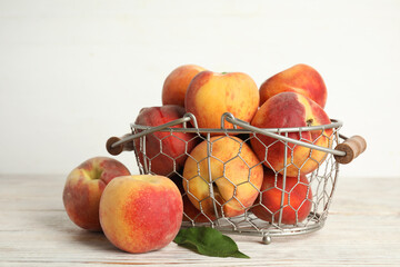 Fresh ripe juicy peaches on white wooden table