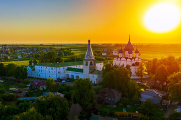 Aerial drone view of Suzdal Kremlin and cathedral of Nativity at the Kamenka river, Russia. Summer sunny day sunset
