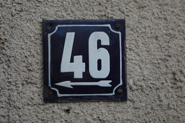 Vintage grunge square metal rusty plate of number of street address with number. Close up, brand.
