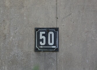 Fototapeta premium Vintage grunge square metal rusty plate of number of street address with number. Close up, brand.