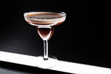 luxury espresso martini cocktail drink in elegant glass on black background