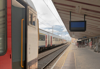 Trains at the station, free track, open door in the carriage, Empty departure board