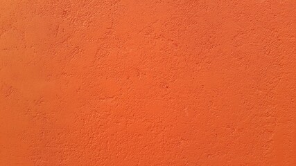 Abstract texture of orange plaster on the walls. Concrete screed. The background image. Copy the place for the text. Construction design surface. Rough wallpaper.