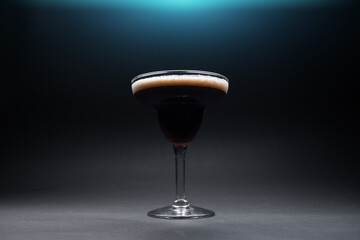 luxury espresso martini cocktail drink in elegant glass on black background