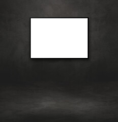 Blank picture frame hanging on a black wall