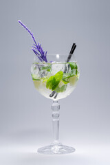 cocktail hugo or mojito with mint, lime and ice in wineglass on white background