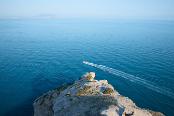boat with passengers at sea, summer vacation, yacht trip in the middle of rocks and mountains, seascape