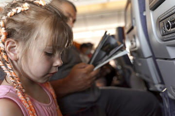 cute child girl with pigtails on the plane.