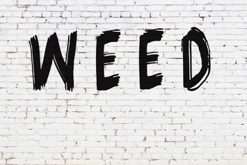 Inscription weed painted on white brick wall © iushakovsky