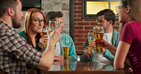 Group of happy tourist young caucasian friend drinking alcohol beer and having fun laugh enjoy hangout party in pub.