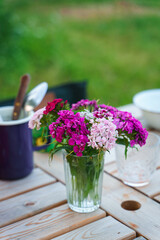 Bouquet of phlox on a garden table served for an outdoor family meal