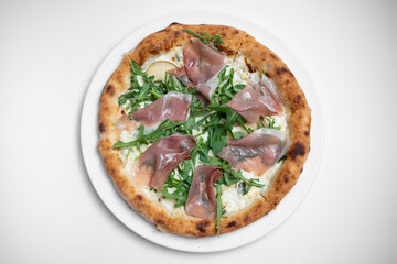 top view of tasty pizza with prosciutto, arugula and cheese on white background