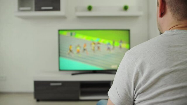 Man's lower back was pinched or ached after he got up from the sofa. Pain in muscle of lumbar region or lower back spine, radiculitis concept. Guy suffers from lumbago in nerves and bones