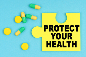 On a blue background, there are pills and a puzzle with the inscription - PROTECT YOUR HEALTH
