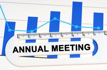 On the sheet with graphs there is a white ruler with the inscription - ANNUAL MEETING