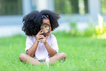 African girl with afro hair sitting watching mushrooms studying nature Concept of learning the natural environment.