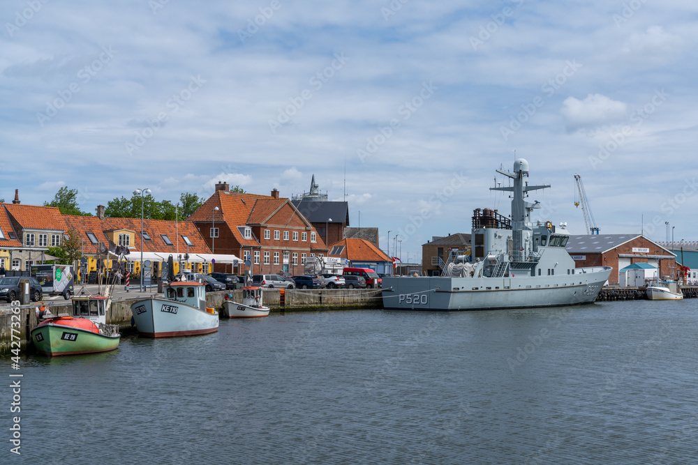 Wall mural the harbor and port of Koge with colorful boats and a warship from the Danish navy