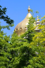 Golden dome inspired by the Brighton Pavilion at Las Rozas shopping mall Madrid Spain in afternoon sun with trees in the foreground © Tony ALS