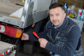 a mailman unloading delivery truck