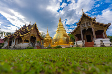 Fototapeta premium Tourist visiting Wat Phra Singh temple one of the best examples of classic Lanna style architecture in Chiang Mai province of Thailand.